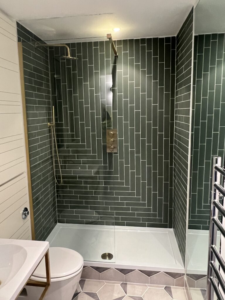 Walk-in shower installation in Newton Mearns with green wall tiles and glass screen