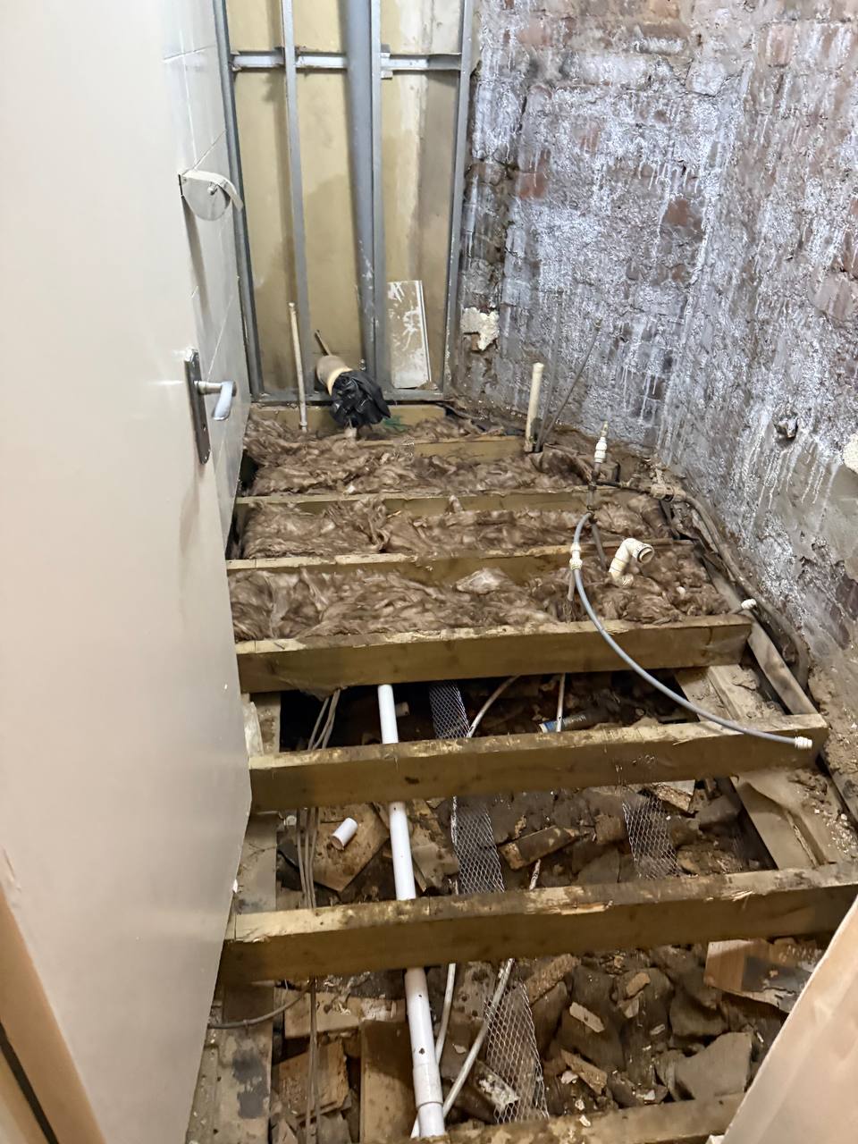Bathroom before renovation Glasgow - floor stripped to joists