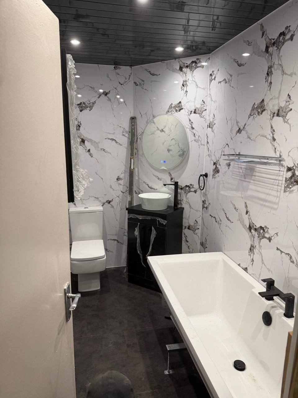 Completed luxury bathroom renovation Glasgow - marble tiles freestanding bath black fittings