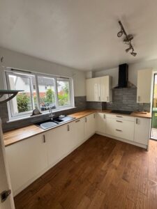 White kitchen with timber worktops and garden window — kitchen fitting Glasgow
