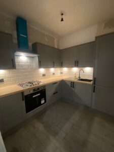 Grey shaker kitchen with wood worktops and metro splashback — Glasgow