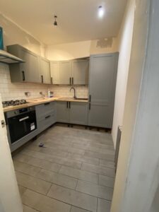 Putty shaker kitchen with black range cooker fitted by Home Decor Zone