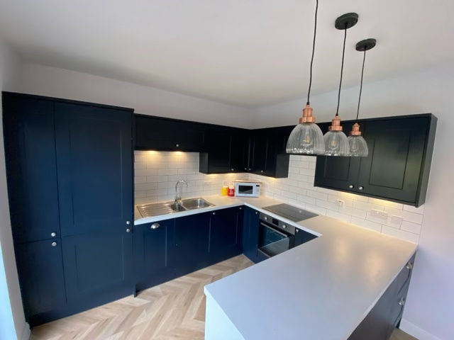 Final view of Clarkston open-plan kitchen with copper pendants and white quartz worktops