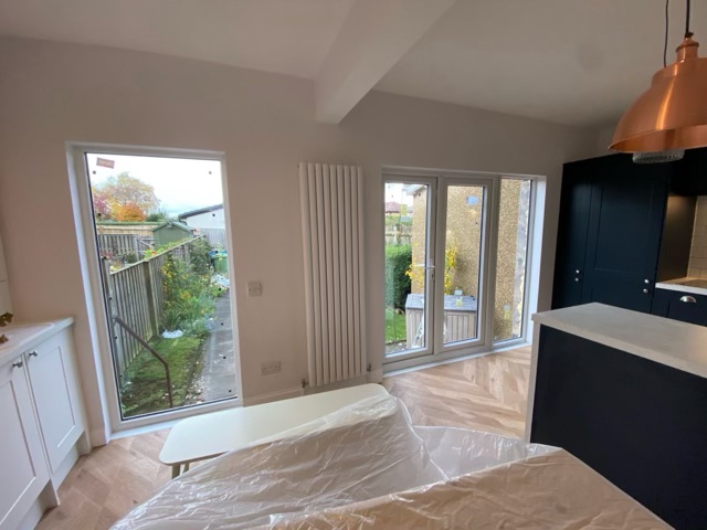 Floor-to-ceiling picture window installed after structural wall removal in Clarkston kitchen