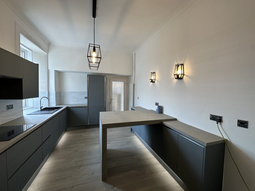 Graphite handleless kitchen with peninsula and plinth lighting fitted in Glasgow by Home Decor Zone