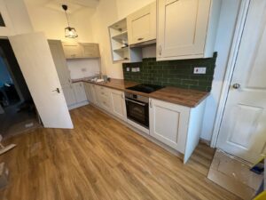 Sage green metro tiles and oak worktop — kitchen renovation Glasgow