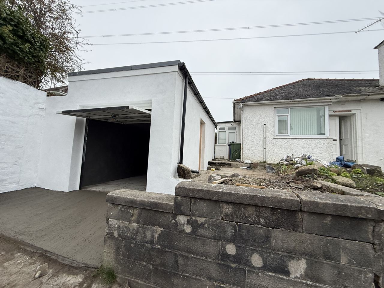 New-build white rendered garage in Glasgow with sectional door - completed by Home Decor Zone builders